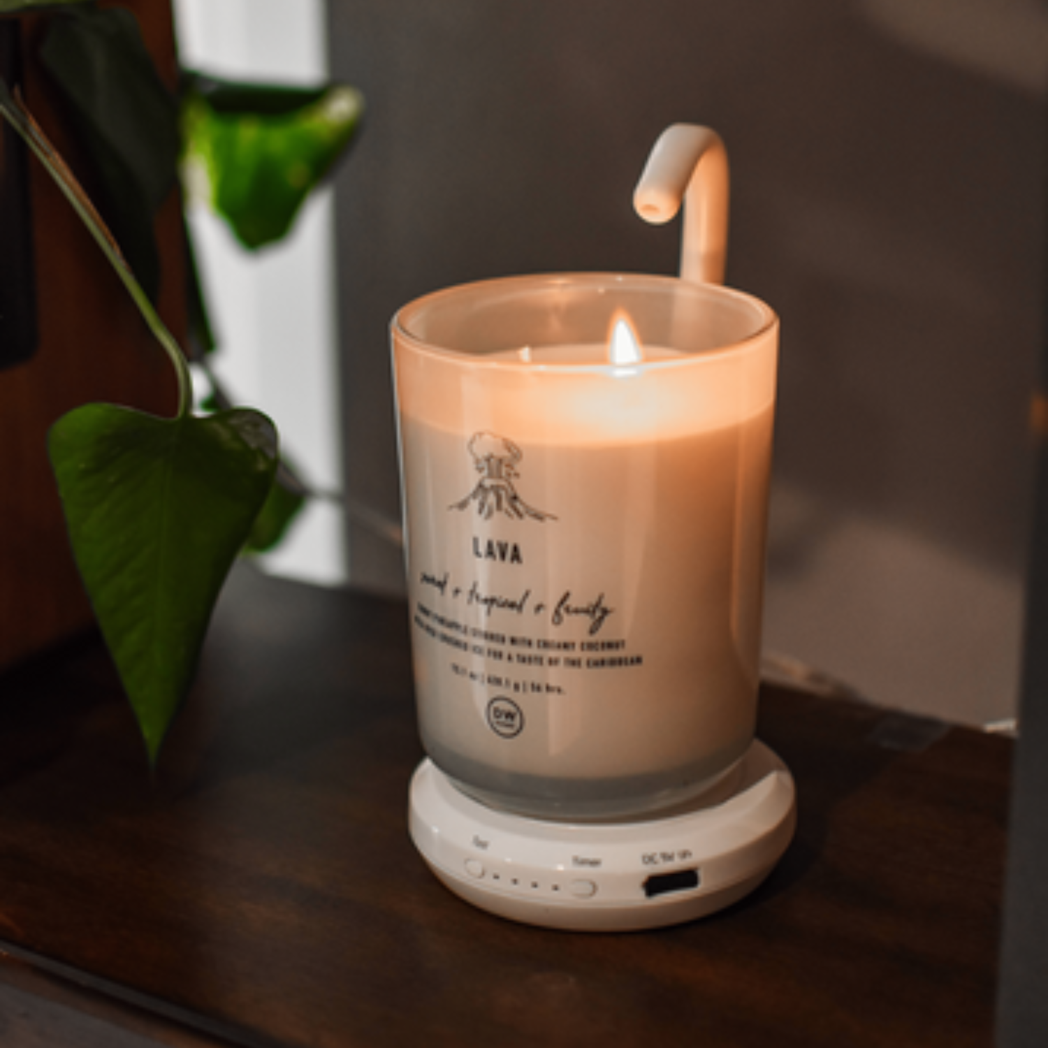 AiryFairy Automated Candle Extinguisher beside a stylish candle, showcasing safety and elegance for home use.